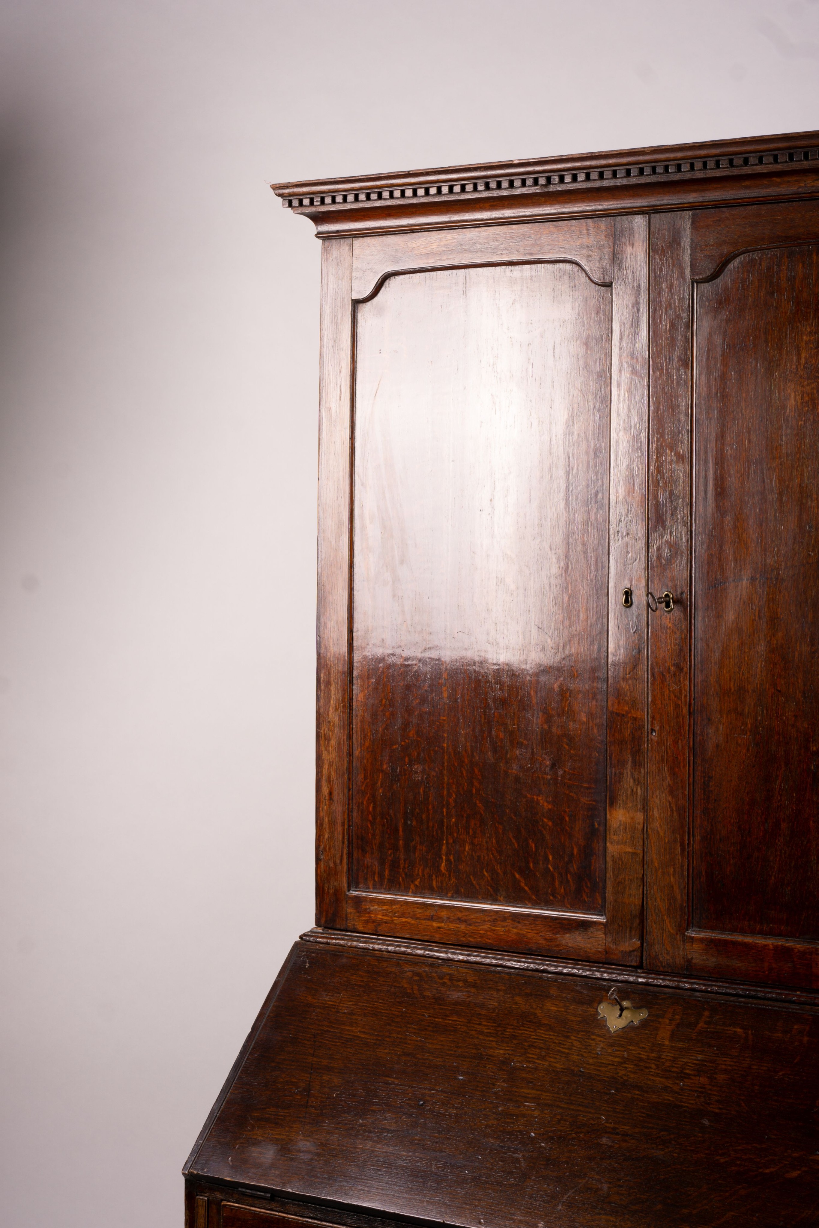 A George III oak bureau cabinet, width 108cm, depth 52cm, height 209cm